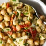 Chick pea salad with marinated artichokes and sun dried tomatoes in a vinaigrette made with fresh lemon juice and extra virgin olive oil.