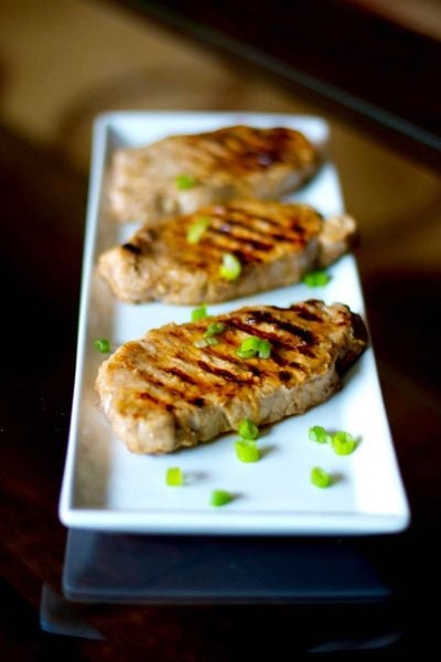 Lemon Ginger Grilled Pork Chops made with center cut boneless pork chops marinated in lemon juice, ginger, honey and soy sauce; then grilled.