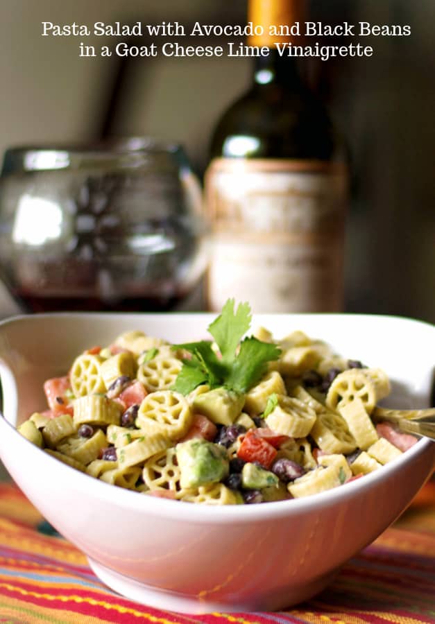 Pasta salad with fresh avocado, black beans and tomatoes in a goat cheese, lime vinaigrette is delicious and super flavorful. 