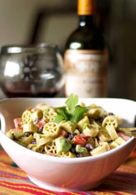 Pasta salad with fresh avocado, black beans and tomatoes in a Goat cheese, lime vinaigrette is delicious and super flavorful. 