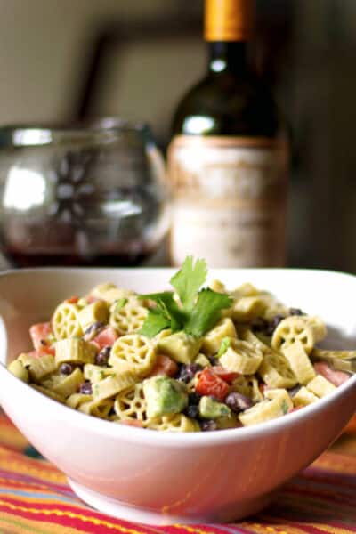 Pasta salad with fresh avocado, black beans and tomatoes in a Goat cheese, lime vinaigrette is delicious and super flavorful. 