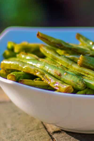 Fresh green beans tossed with fresh garlic, soy sauce and a light oil; then roasted until tender make a delicious side dish to any Asian style meal. 