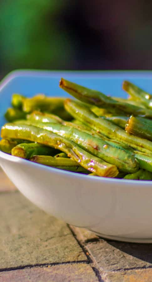 Fresh green beans tossed with fresh garlic, soy sauce and a light oil; then roasted until tender make a delicious side dish to any Asian style meal. 