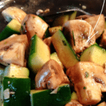 a bowl of diced zucchini and mushrooms