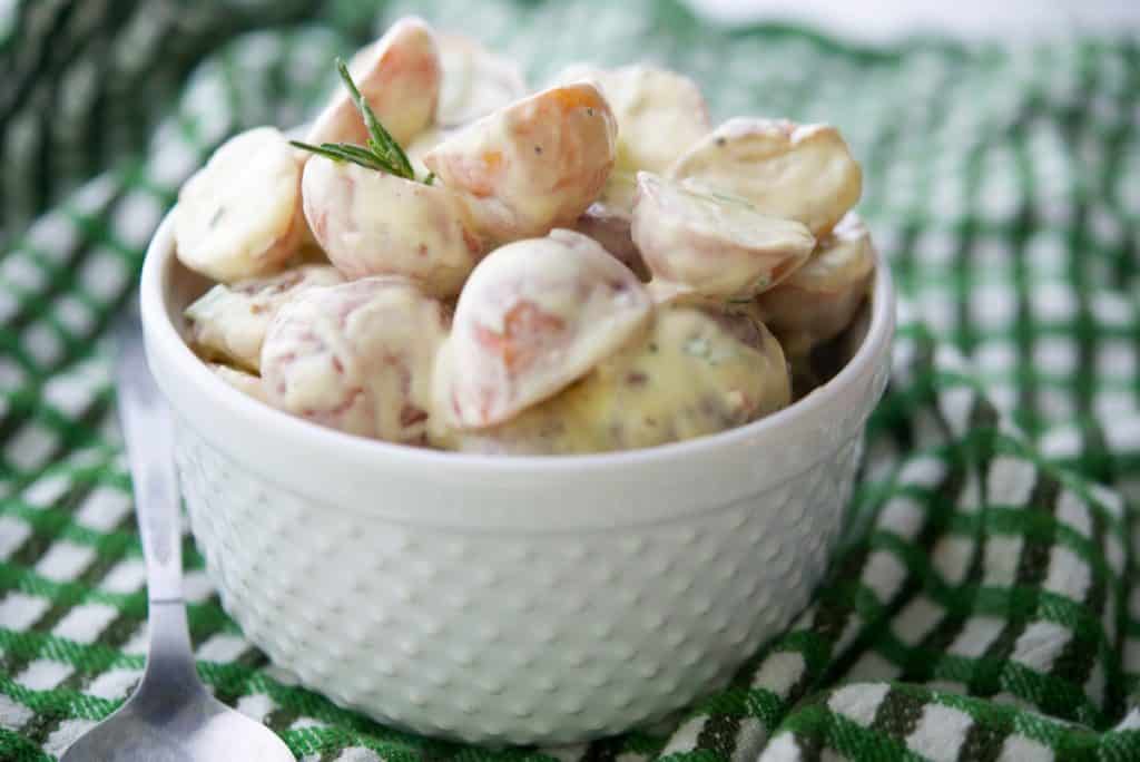 Dijon Red Bliss Potato Salad in white serving bowl