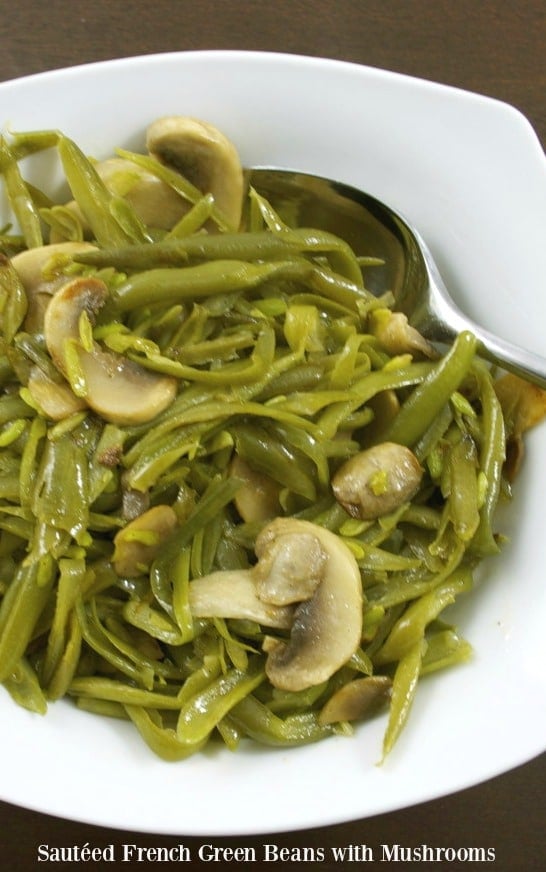 French green beans sautéed with fresh mushrooms, butter and garlic powder in a bowl.
