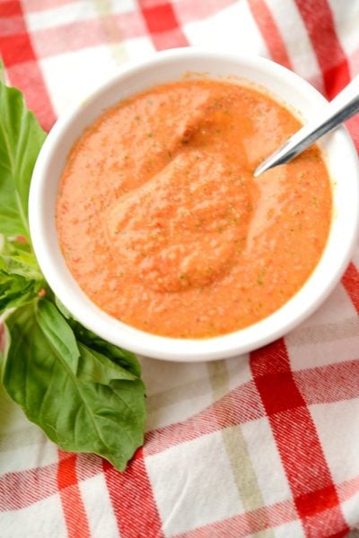 A bowl of Grape tomato vinaigrette with a spoon