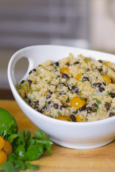 Quinoa tossed with black beans and golden sunburst tomatoes in a lime and ginger vinaigrette dressing makes a refreshingly tasty light salad.
