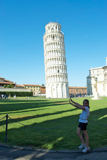 A person standing in front of Leaning Tower of Pisa