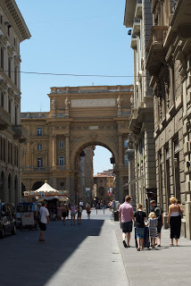 A group of people walking on a city street