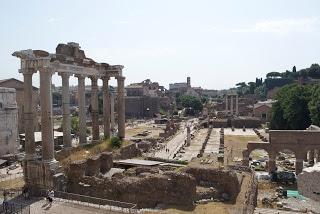 A large stone building with Roman Forum in the background