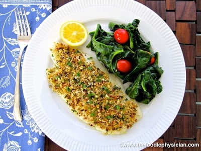 A plate of food on a table, with Flounder Oreganata