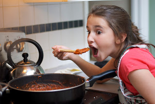 Gabby tasting the sausage bolognese sauce