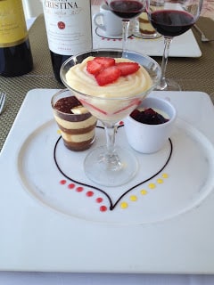 A plate with a glass of dessert