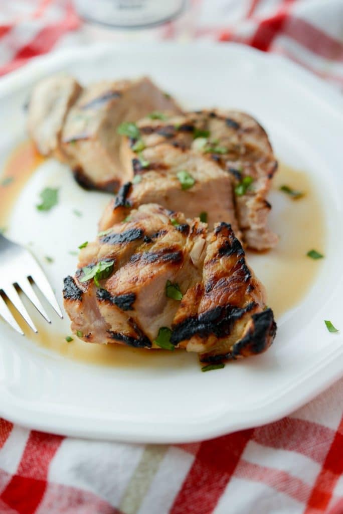 A plate of corona grilled pork chops with a fork