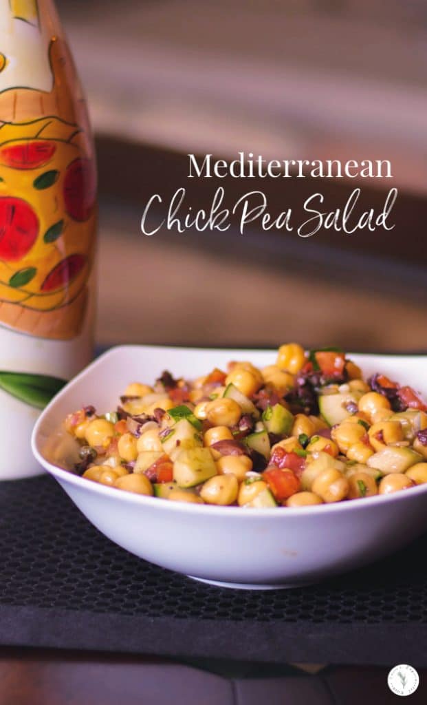 Mediterranean Chick Pea Salad made with capers, Kalamata olives, cucumbers, tomatoes and fresh basil in a balsamic vinaigrette. 