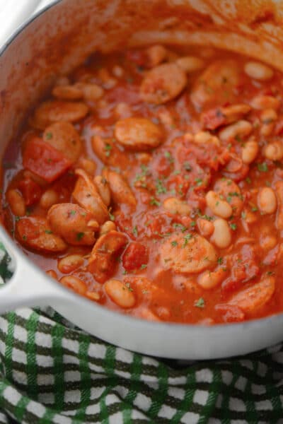 a white pot of chicken sausage and bean stew