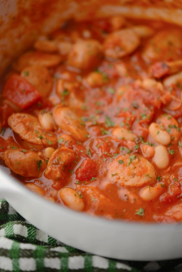 a pot of sausage, beans and tomatoes