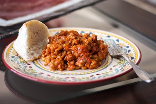 A plate of italian sausage white bean stew