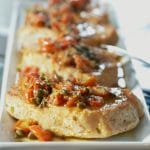 Pan Seared Pork in a White Wine, Tomato & Caper Sauce is a deliciously light and flavorful weeknight meal. It's ready in under 30 minutes and is made in one pan for easy cleanup!