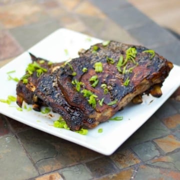 Pork spareribs slowly simmered until they're fall-off-the-bone tender; then brushed with an Asian Marinade and grilled to perfection.