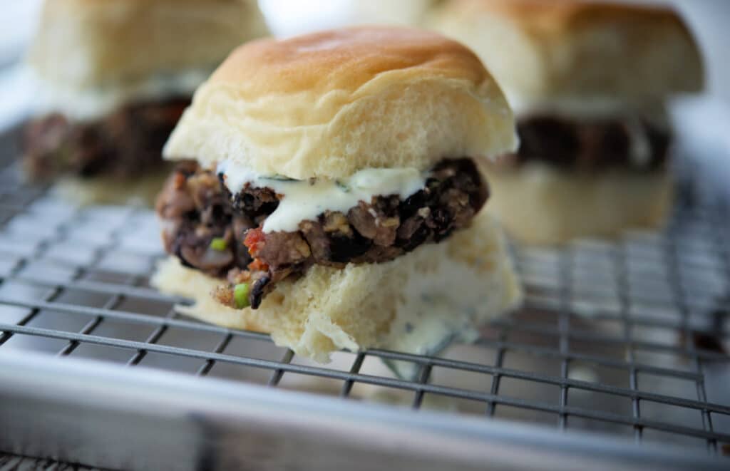 a close up of a greek black bean slider