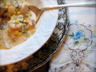 A bowl of food on a plate, with Seafood and Soup