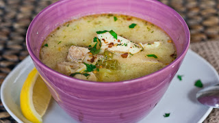A bowl of food on a plate, with Soup