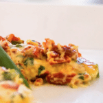 a piece of chicken on a plate with sun dried tomato cream sauce