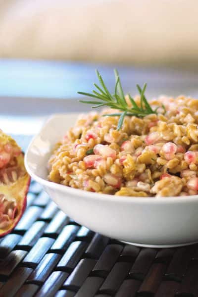 A bowl of Farro Salad with Pomegranate, Goat cheese and Walnuts