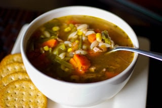 A bowl of Italian vegetable beef soup with a spoon