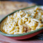 Three Cheese Mac n' Cheese made with Velveeta, Asiago and Pecorino Romano cheeses, topped with a buttery crust; then baked.