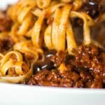 Fettuccine with Sausage Puttanesca Sauce made with sweet Italian sausage, Kalamata olives, capers, garlic, plum tomatoes and red wine.