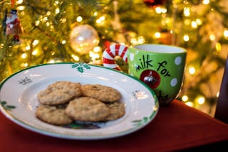 A plate of Oatmeal Toffee Cookies in front of a Christmas tree.