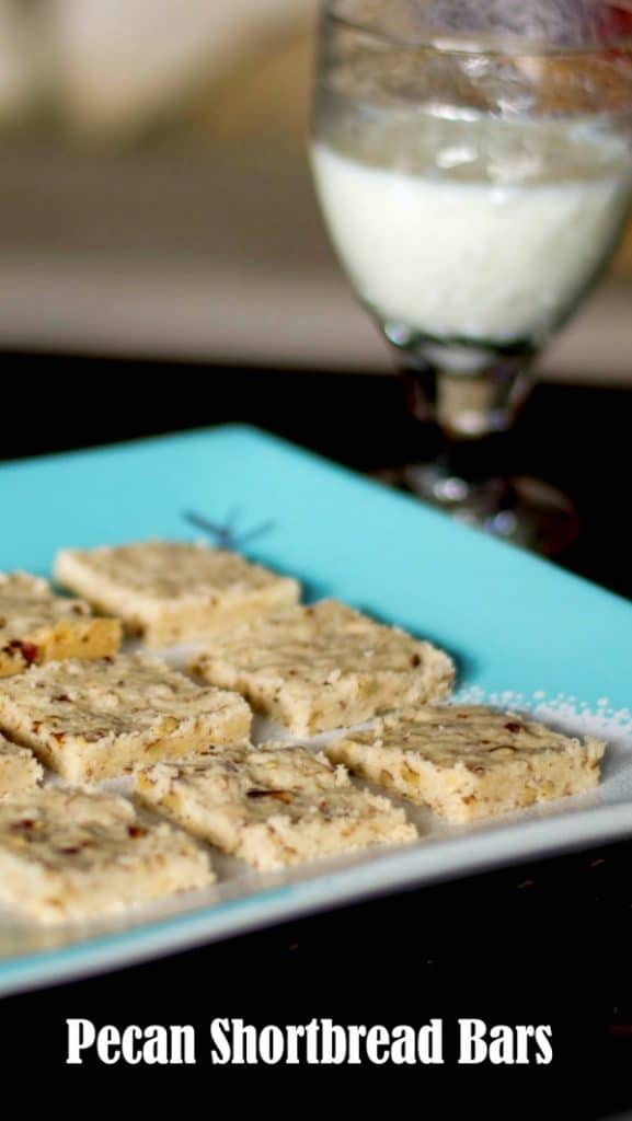 Pecan Shortbread Bars on a plate with a glass of milk