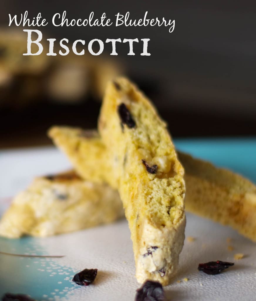 White Chocolate Blueberry Biscotti on a plate with text. 