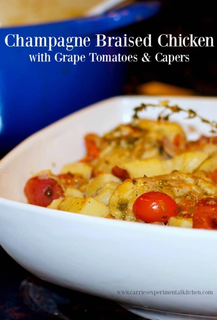 Chicken thighs braised in a Dutch oven with champagne, grape tomatoes, capers and red potatoes make a tasty one pot meal. 