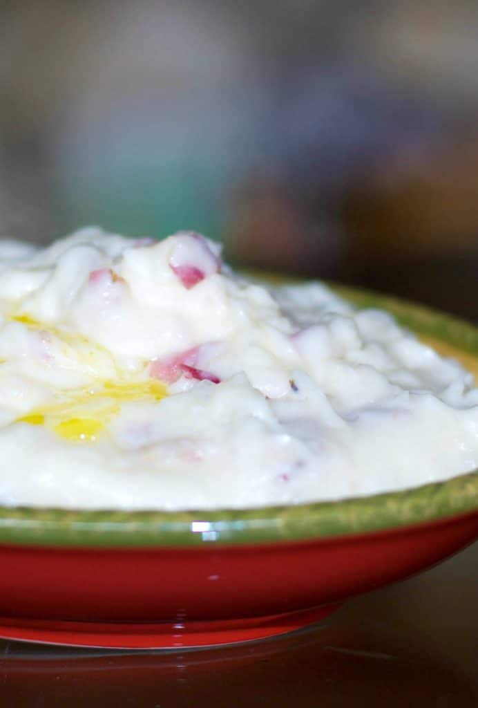 A close up of mashed potatoes with melted butter. 