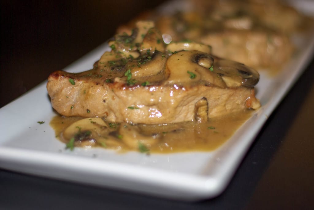 Pork pan seared with Dijon mustard and fresh mushrooms in a light sauce. 