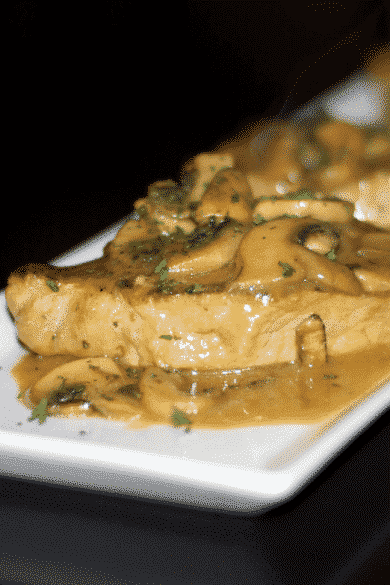 Boneless center cut pork chops pan seared on top of the stove with fresh, white mushrooms in a light Dijon mustard sauce.