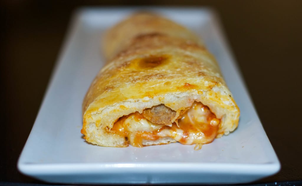 Meatball Stromboli on a white plate. 