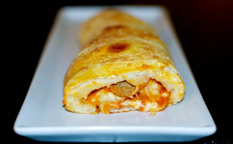 A close up of meatball stromboli