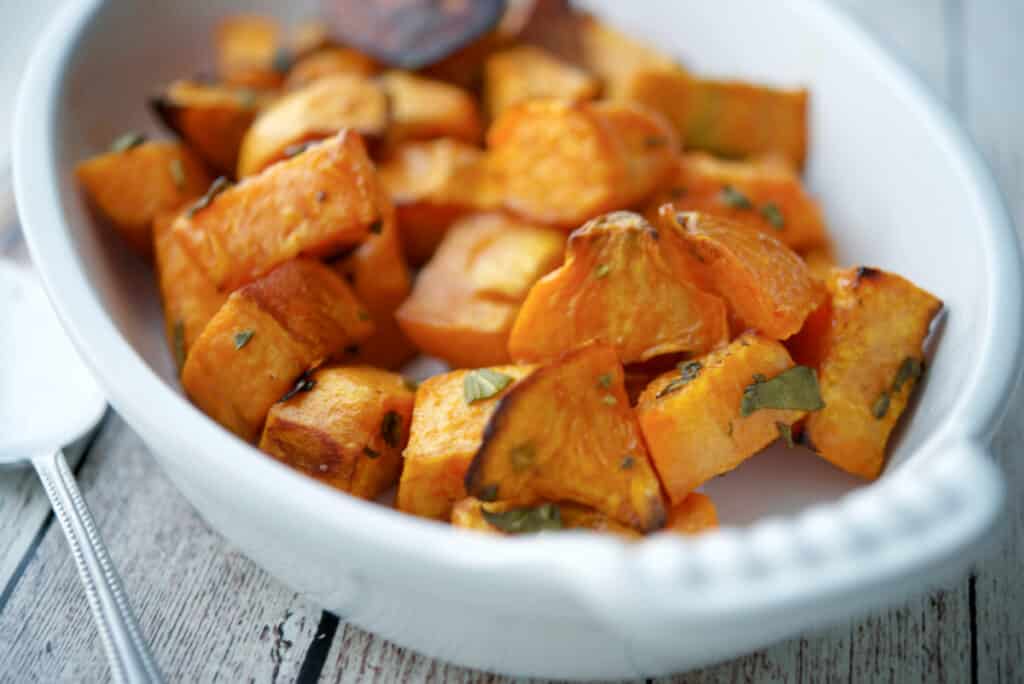 Roasted sweet potatoes in a white baking dish