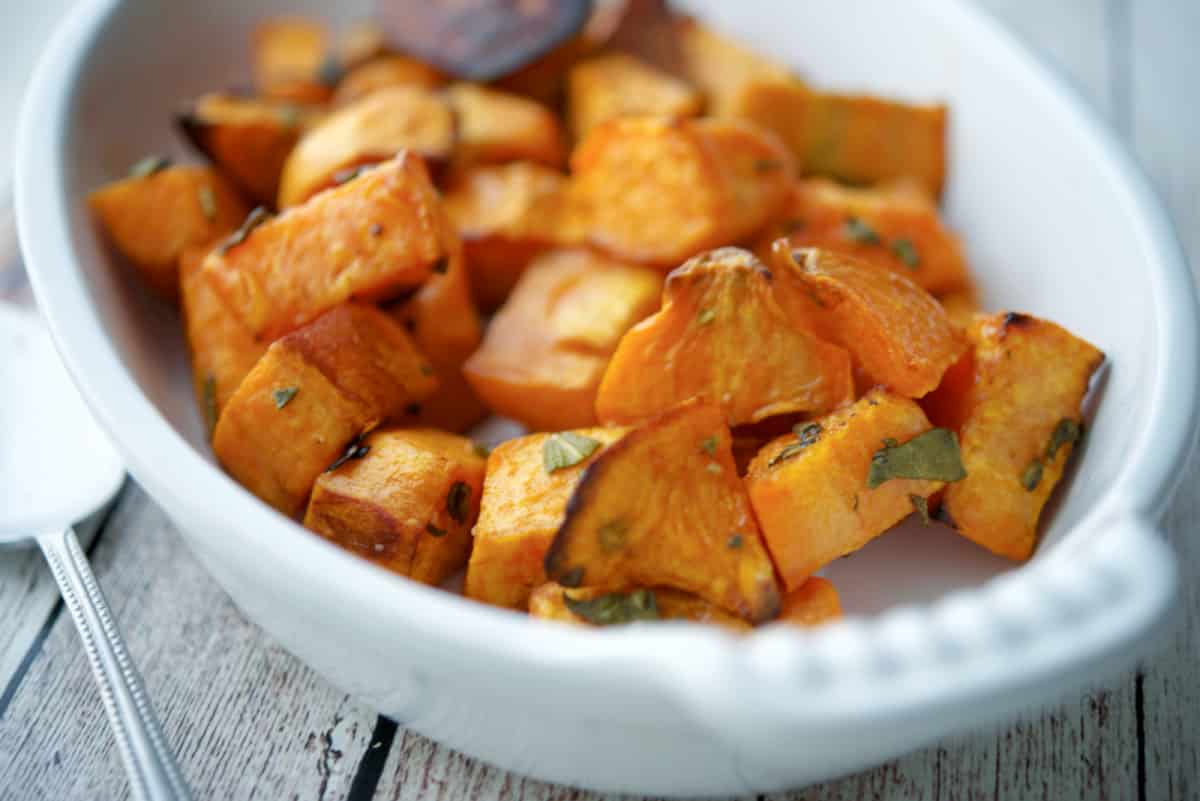 Roasted sweet potatoes in a white baking dish