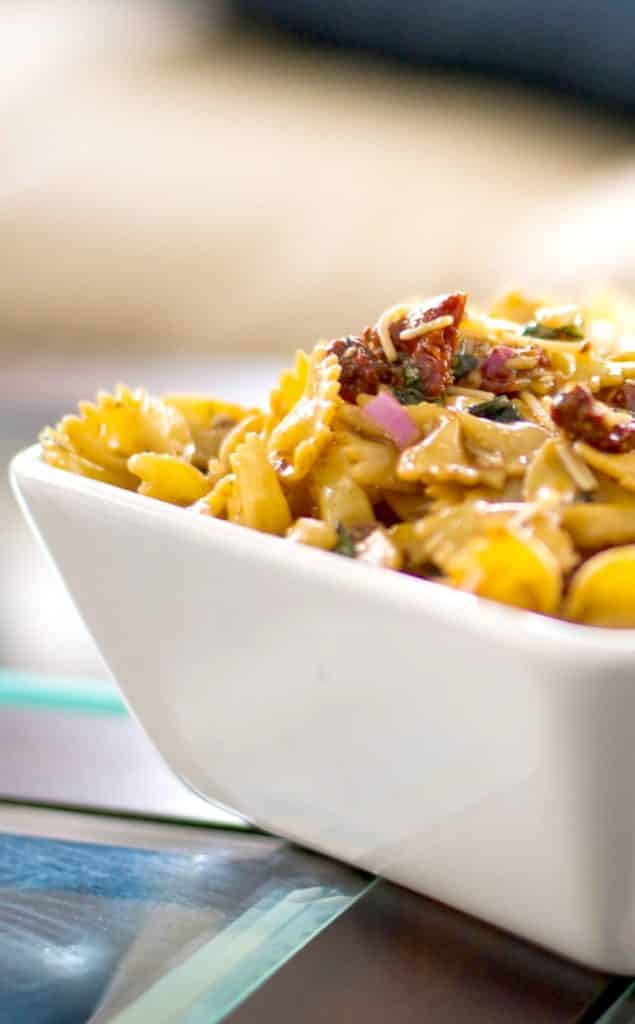 Sun Dried Tomato and Asiago Cheese Pasta Salad in a white square bowl