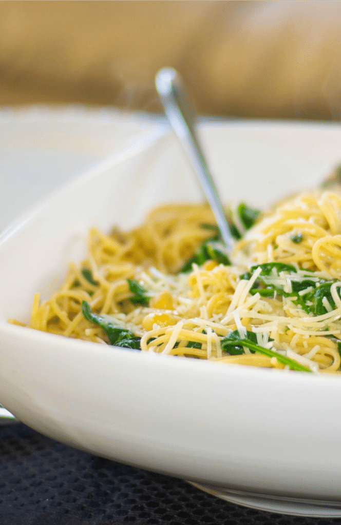  Whole Grain Spaghetti with Sauteéd Chick Peas and Spinach in a white pasta bowl. 