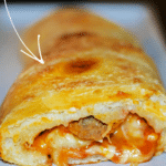 a close up of meatball stromboli cut open