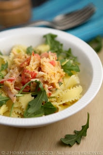 A bowl of food on a plate, with Pasta and Seafood