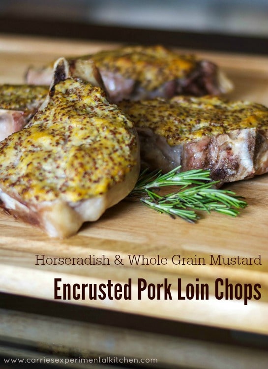 A close up pork chops on a cutting board topped with horseradish and mustard.