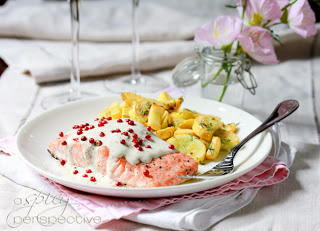 A plate of food on a table, with salmon